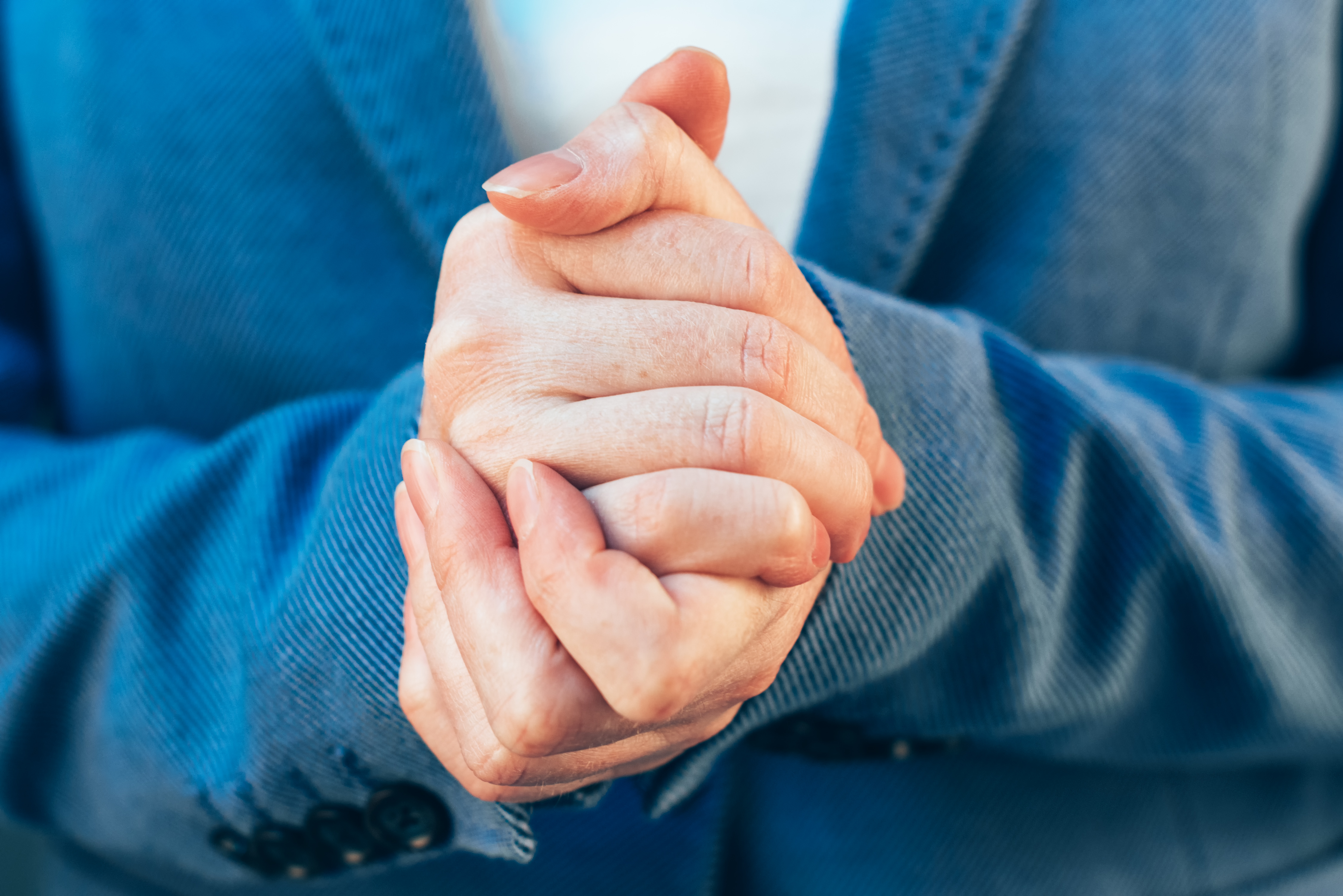 nervous-businesswoman-hands-close-up-PN97CAV